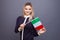 Immigration and the study of foreign languages, concept. A young smiling woman with a Italy flag in her hand.