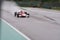 Imola, Italy 28 April 2019: vintage formula one car is flying on a wet track, panning photo