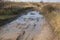 Impassable dirt road. Puddle and dirt on the road