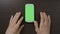 Impatient teenage male touching digital green screen smartphone waiting to load media contents on social network or websites -