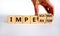 Imperator or impeachment symbol. Businessman hand turns wooden cubes and changes the word `imperator` to `impeachment`. Beauti