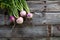 Imperfect organic turnips, fresh green tops on authentic wood background