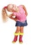 An impish little blond girl in blouse, skirt and rubber boots is