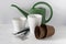 Implement for home gardening. Small shovel and rake, white ceramic flower pots, plastic containers and watering can. Houseplant