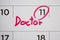 Important doctor appointment schedule write on white calendar page date close up