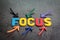 Important of focus, concentration, intention in work or life concept, colorful arrows pointing to the word FOCUS at the center on