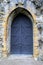 Imposing black doors in stone archway
