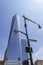 The imposing building of One World Trade Center with a street light in the foreground with the street sign of Liberty St. New York