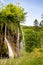 An imposing waterfall with a large flow of water rises through a rock formation in the national park.