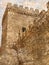 Impregnable fortress wall with a watchtower. High Medieval forti