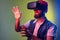 Impressed bearded hipster man standing in vr, playing video game and trying to touch something.