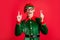 Impressed crazy elf raise finger hold light bulb creative think concept wear green costume isolated on red shine color