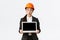 Impressed and excited asian female engineer showing amazing results on graph, industrial technician in safety helmet and