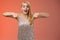 Impressed excited attractive glamour blond girl in silver glittering dress gasping thrilled pointing down glance camera