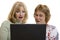 Impressed women looking at computer screen