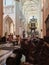 An impressing interior of a cathedral with a lions` figure in front of a scene. Brugge, Belgium
