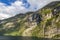 Impression from cruise ship on the way through Geiranger fjord in Norway at sunrise in summer