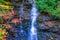 Impressionistic Style Artwork of an Autumn Waterfall