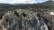 An impressive aerial view of a group of high rocks in summer. Shot. Natural landscape with wild rock formations covered