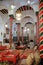 The impressive colorful interior of El Mrabet Cafe, located inside the medina, with twisted columns, a high vaulted ceiling