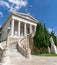 Impressive curved marble stairs and neo-classical facade of the national library of Athens.