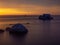 Impressive dawn on the lake. Stones in the water