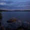 Impressive dawn on the lake. Stones in the water