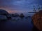 Impressive dawn on the lake. Stones in the water