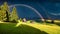 Impressive evening scene of Compaccio village with huge rainbow on background, Seiser Alm or Alpe di Siusi location, Bolzano