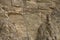 Impressive huge steep wall in a surface quarry, stone texture