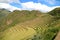 Impressive Inca agricultural terraces with the ancient ruins at Pisac archaeological complex, Sacred Valley of the Inca, Cusco