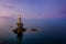 A impressive lighthouse on a rock in the sea during dusk