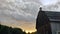 Impressive, magnificent, irreplaceable canadian barn in sunset. Cloudy sky. Sunset:   Haut Gaslesie. Quebec.