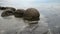 Impressive Moeraki boulders in the Pacific Ocean waves