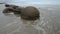 Impressive Moeraki boulders in the Pacific Ocean waves