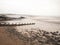 Impressive overcast seaside beach scene groynes pebbles mudflats