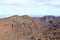 Impressive panoramic landscape of clouds and volcanic mountains from the top of the Roque de los Muchachos viewpoint, on the