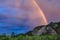 An impressive rainbow over a mountain range in Kuray steppe of Altai Krai