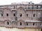 Impressive reddish-toned facade of the Mehrangarh Fort in the blue city of Jodhpur, India