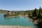 An impressive rock in the water of the Taibilla reservoir in sunshine.