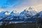 Impressive snowy mountain peaks with the reflection of the sun in a beautiful sunset.