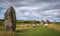 Impressive standing stones from the historic circle in Avebury Wiltshire. Sheep can be seen grazing amongst the massive rocks