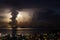 Impressive storm with huge lightening behind a vertical cloud.