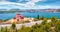 Impressive summer cityscape of Ermioni port and Greek Orthodox church St. Gerasimos on foreground.