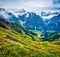 Impressive summer view from the top of Grindelwald First cableway. Schreckhorn mountain in the morning mist, Grindelwald village l