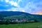 Impressive sunset with orange setting sun and blue/purple clouds, over Rimetea village, Alba county, Transylvania, Romania