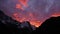 Impressive sunset over snow-capped mountain range in the Himalayas near Thame, Nepal with dramatic orange and purple sky.