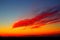 Impressive sunset scenery with spindrift red clouds crossing the sky