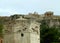 The impressive upper part of the Tower Of The Winds against the ancient Greek temple on the hilltop of Acropolis, Athens