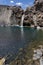 Impressive vertical photo of turquoise light blue waterfall located in the Cajon del Maipo, Andes Mountains called Salto el Yeso,